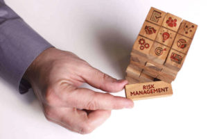 Hand pulling a risk management tile